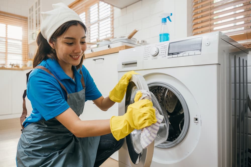 Technician servicing a home laundry appliance
