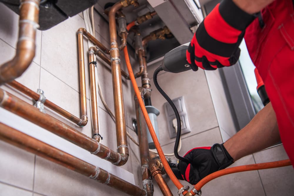 Technician testing copper plumbing lines