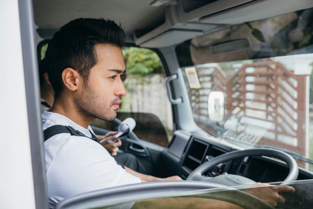 Technician driving a service van between jobs